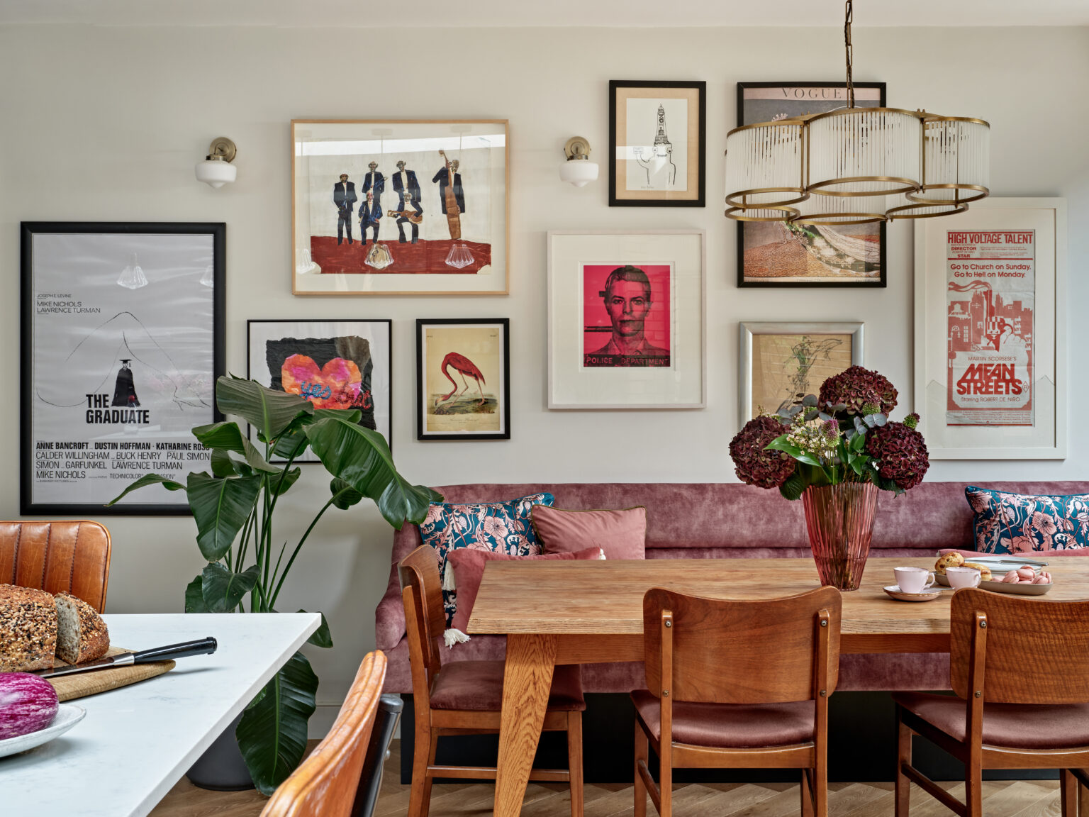 Dining space with banquette seating and gallery wall, Hornsey