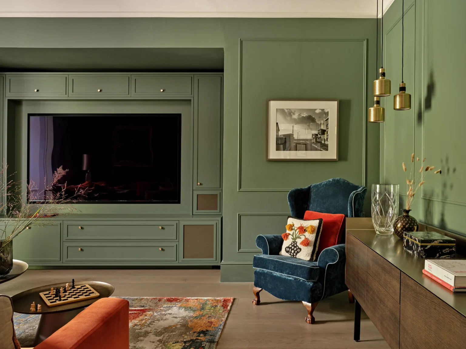 Bespoke sage-green panelled media wall and fitted cabinetry by Garrity, Highgate