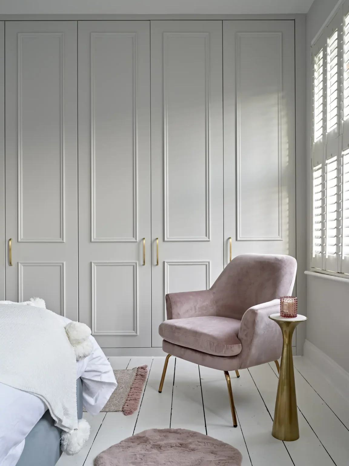 Floor-to-ceiling bespoke fitted wardrobes by Garrity in a Crouch End bedroom