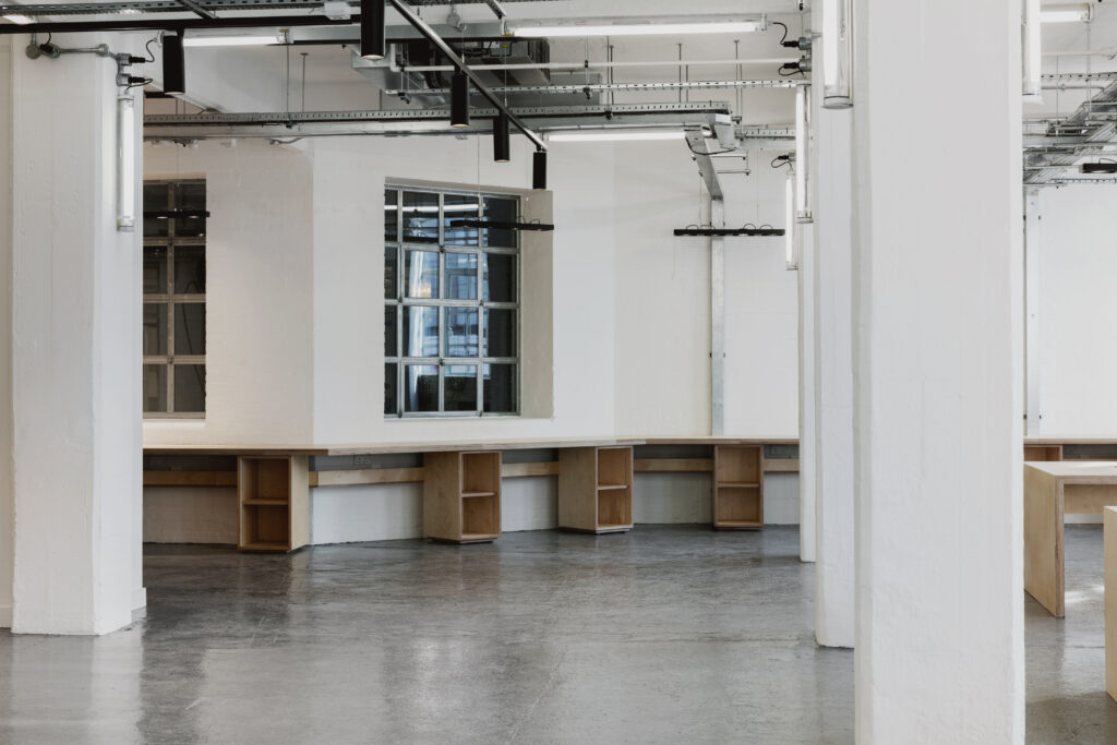 Workbenches beneath the windows with exposed brick piers