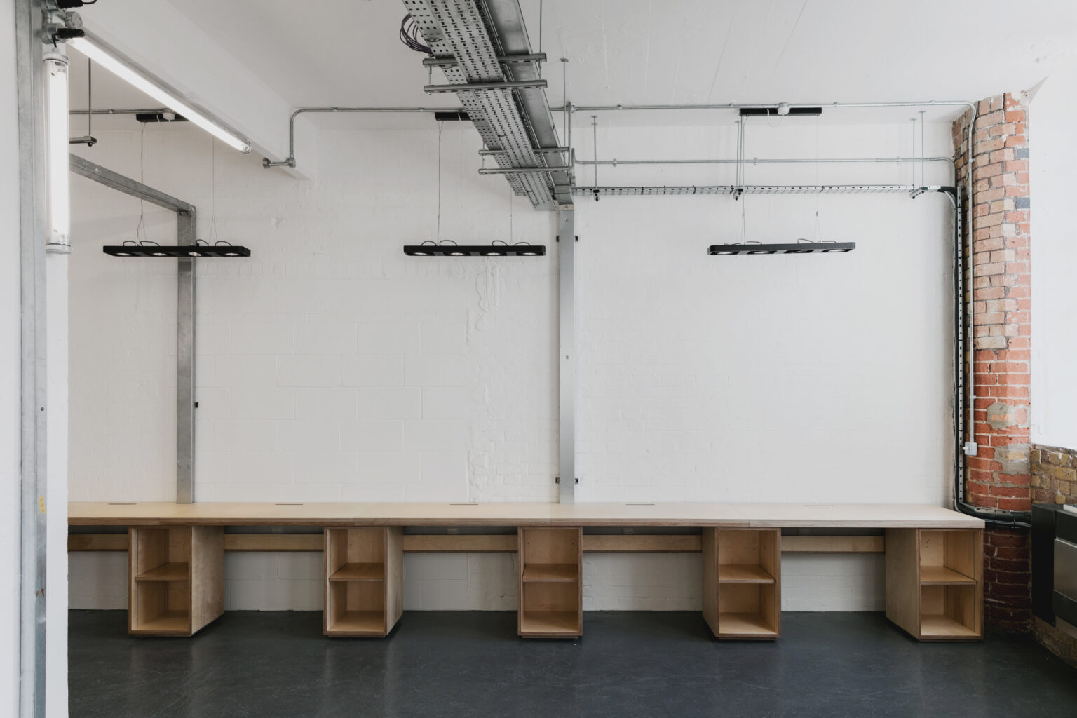 Bespoke plywood bench seating in a Shoreditch workspace