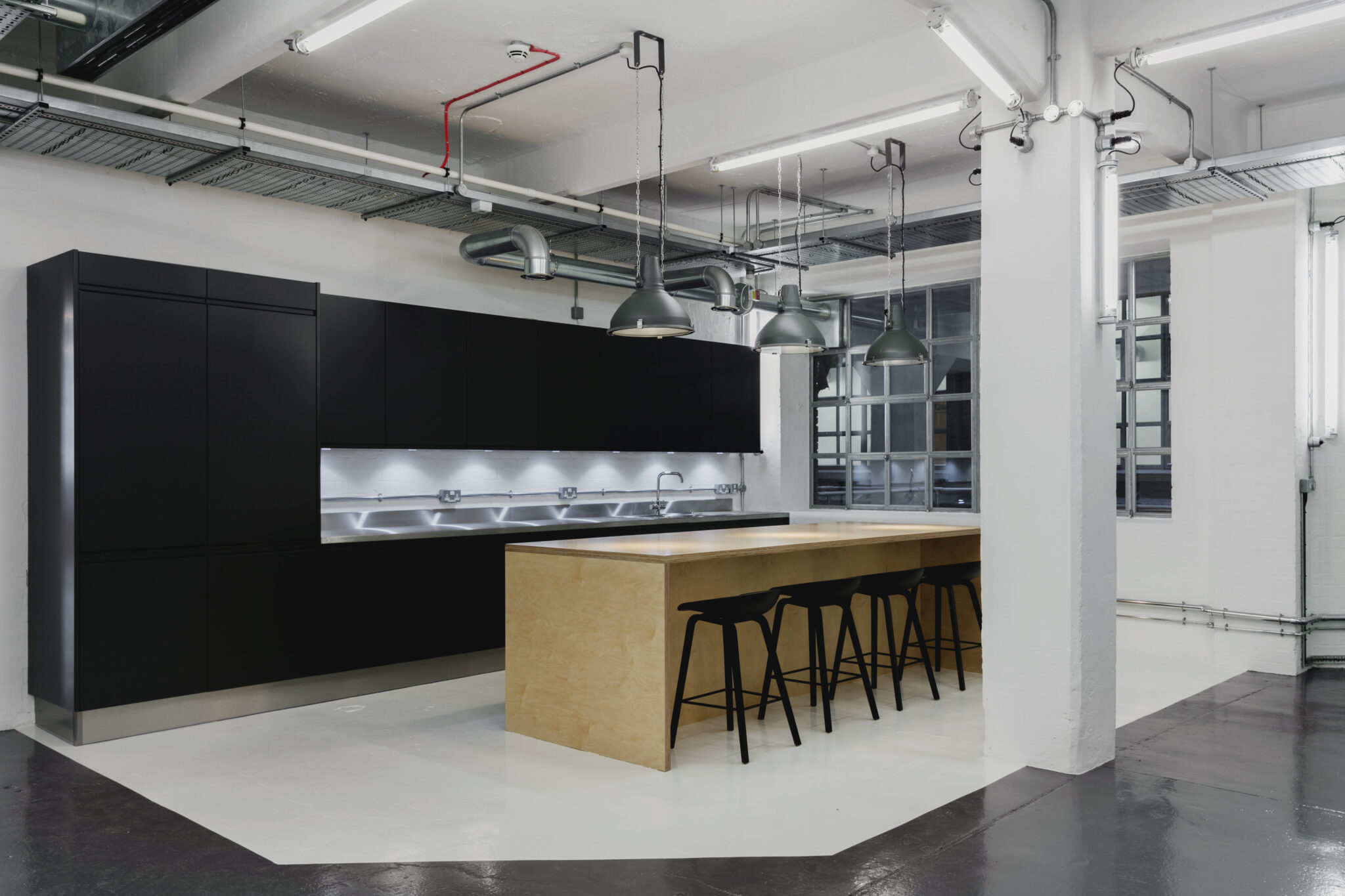 Kitchen and island seen from the main workspace floor